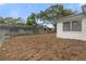 Back exterior, fenced backyard with potential garden space at 12407 Gunstock Ln, Hudson, FL 34667