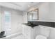 Bright bathroom features tiled shower, modern vanity, and neutral color palette at 12407 Gunstock Ln, Hudson, FL 34667