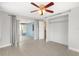 Neutral bedroom with access to enclosed patio and closet at 12407 Gunstock Ln, Hudson, FL 34667