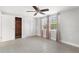 Bedroom featuring tile floors, ceiling fan, and closets at 12407 Gunstock Ln, Hudson, FL 34667