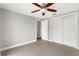 Bedroom featuring tile floors, a ceiling fan, and a closet with sliding doors at 12407 Gunstock Ln, Hudson, FL 34667