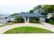 Charming single-story home featuring a well-maintained lawn and landscaping at 12407 Gunstock Ln, Hudson, FL 34667