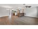 Open-concept living area flowing into a stylish kitchen with wood flooring at 12407 Gunstock Ln, Hudson, FL 34667