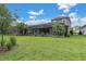 Expansive backyard with mature trees and lush green grass at 12539 Wetmore Ct, Odessa, FL 33556