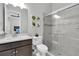 Bathroom with shower, sink, and toilet and plant decorations on wall with view to bedroom at 12539 Wetmore Ct, Odessa, FL 33556