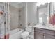 Bathroom featuring a shower and bath combo with tile surround, neutral paint and vanity with modern fixtures at 12539 Wetmore Ct, Odessa, FL 33556