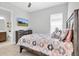 Light and bright bedroom with a large window, television and attached bath with neutral paint and luxury vinyl floors at 12539 Wetmore Ct, Odessa, FL 33556