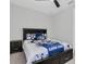 Bright bedroom featuring baseball themed bedding, carpet floors, ceiling fan and a dark wood bed frame and bedside table at 12539 Wetmore Ct, Odessa, FL 33556