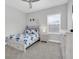 Comfortable bedroom with a butterfly themed comforter, carpet flooring, and a bright window at 12539 Wetmore Ct, Odessa, FL 33556