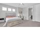 Bright bedroom featuring a small desk, carpet floors, a ceiling fan and access to a bathroom at 12539 Wetmore Ct, Odessa, FL 33556