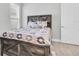 Bright bedroom featuring wood-look floors, large window and farmhouse style bed with light neutral paint at 12539 Wetmore Ct, Odessa, FL 33556