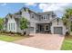 Stunning two-story home with a three-car garage, beautiful landscaping, and a brick-paved driveway at 12539 Wetmore Ct, Odessa, FL 33556