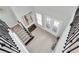 Bright foyer featuring wood flooring, a staircase with iron railings, and a charming bench at 12539 Wetmore Ct, Odessa, FL 33556