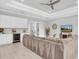 Spacious living room with white cabinets, a wine fridge, and a comfortable sectional sofa at 12539 Wetmore Ct, Odessa, FL 33556
