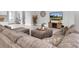 Bright and spacious living room with a large sectional sofa, wooden entertainment center, and modern decor at 12539 Wetmore Ct, Odessa, FL 33556