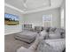 Spacious living room with a large sectional, tv, ceiling fan, and tray ceilings at 12539 Wetmore Ct, Odessa, FL 33556