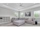 Cozy living room with a large sectional sofa, tray ceilings, and abundant natural light at 12539 Wetmore Ct, Odessa, FL 33556