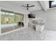 Outdoor kitchen featuring a stainless steel grill, tv, and views of the pool and greenery at 12539 Wetmore Ct, Odessa, FL 33556