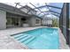 The sparkling pool includes walk-in steps, an outdoor bar and a covered patio with ceiling fan at 12539 Wetmore Ct, Odessa, FL 33556