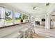 Inviting bar area perfect for entertaining, featuring ample seating, bright light, and views to the kitchen at 13039 Topflite Ct, Hudson, FL 34669
