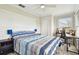 Comfortable bedroom with stylish decor, including a modern headboard and a desk with an office chair at 13039 Topflite Ct, Hudson, FL 34669