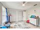Bedroom with light-colored floors, multiple closets, and a ceiling fan at 13039 Topflite Ct, Hudson, FL 34669