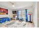Bright, playful bedroom with a Spider-Personal theme, including a TV, desk and basketball hoop at 13039 Topflite Ct, Hudson, FL 34669