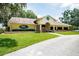 Exterior of the Meadow Oaks Golf & Country Club with lush green lawns at 13039 Topflite Ct, Hudson, FL 34669