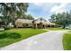Exterior of the Meadow Oaks Golf & Country Club with lush green lawns at 13039 Topflite Ct, Hudson, FL 34669