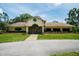Exterior of the Meadow Oaks Golf & Country Club with lush green lawns at 13039 Topflite Ct, Hudson, FL 34669