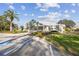 Attractive clubhouse with a palm tree and accessible parking on a sunny day at 13039 Topflite Ct, Hudson, FL 34669