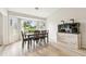 Bright dining room featuring a modern table set, large windows, and a decorative aquarium at 13039 Topflite Ct, Hudson, FL 34669