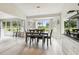 Dining area with ample natural light, a modern light fixture, and views of the backyard at 13039 Topflite Ct, Hudson, FL 34669