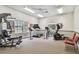 Bright fitness center equipped with a treadmill, elliptical machine, weight machines, and ample space for workouts at 13039 Topflite Ct, Hudson, FL 34669