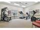 Functional fitness center featuring cardio equipment, weight machines, ample natural light, and a comfortable workout environment at 13039 Topflite Ct, Hudson, FL 34669