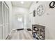 Clean and bright foyer with a decoratively tiled door and convenient shoe storage at 13039 Topflite Ct, Hudson, FL 34669