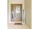 Front door with glass, a welcome mat, and a welcome sign creates a warm and inviting entrance at 13039 Topflite Ct, Hudson, FL 34669