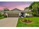 Charming single-story home with well-manicured lawn, mature trees and attached two car garage at 13039 Topflite Ct, Hudson, FL 34669