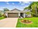 Charming single-story home with well-manicured lawn, mature trees and attached two car garage at 13039 Topflite Ct, Hudson, FL 34669