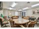 Versatile game room with multiple tables, comfortable seating, neutral decor, and ample space for various activities at 13039 Topflite Ct, Hudson, FL 34669