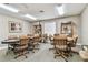 Well-lit game room with card tables, a poker table, comfortable chairs, and shelving for decorative items and storage at 13039 Topflite Ct, Hudson, FL 34669