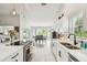 Open kitchen featuring sleek countertops, stainless steel appliances, and seamless access to dining area at 13039 Topflite Ct, Hudson, FL 34669