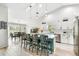 Bright kitchen featuring an island with seating, stainless steel appliances, and an adjacent dining area at 13039 Topflite Ct, Hudson, FL 34669
