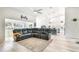 Open-concept living space with a cozy sectional sofa, views of the kitchen and vaulted ceilings at 13039 Topflite Ct, Hudson, FL 34669