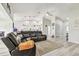 Inviting living room featuring a large leather sectional, light wood floors, and vaulted ceilings at 13039 Topflite Ct, Hudson, FL 34669