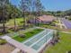 A new state of the art shuffleboard court with picnic tables is surrounded by lush landscaping at 13039 Topflite Ct, Hudson, FL 34669