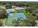 Aerial shot of community tennis and pickleball courts, adjacent to a pool and clubhouse at 13039 Topflite Ct, Hudson, FL 34669