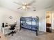 Bedroom with a blue bunk bed, desk, chair, ceiling fan, and carpeted floors, perfect for children at 13850 Royston Bnd, Hudson, FL 34669