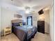 Comfortable bedroom with queen-sized bed, dark wooden dresser, ceiling fan, and a cozy atmosphere at 13850 Royston Bnd, Hudson, FL 34669