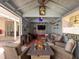 Relaxing cabana features a sofa, chairs, and a cozy fire pit perfect for entertaining and unwinding at 13850 Royston Bnd, Hudson, FL 34669